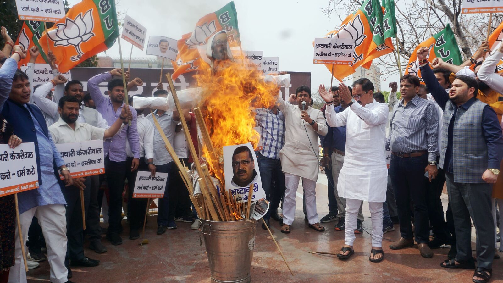 ‘Holika of corruption’: BJP burns effigies of AAP supremo Arvind Kejriwal, seek resignation of Delhi CM