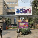 Nine Adani group firms climb in early trade; NDTV shares goes lower by 2%